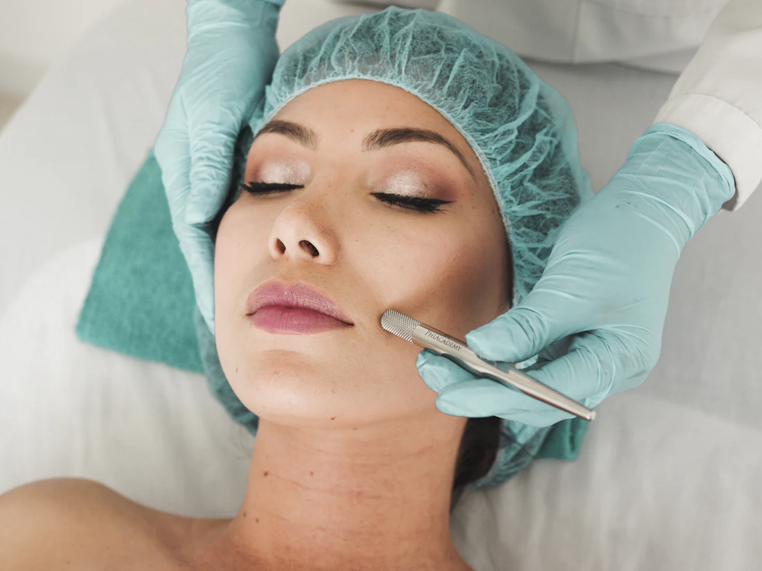 A skincare specialist performing a facial treatment